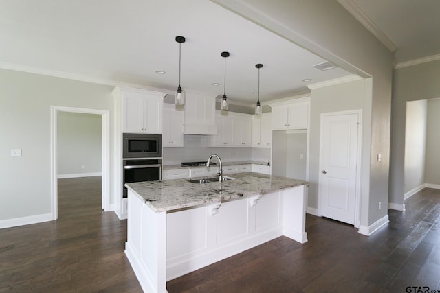 11747 Jayden Ln, Tyler, TX 75703 - kitchen featuring appliances with stainless steel finishes, white cabinetry, premium range hood, ornamental molding, and light stone counters