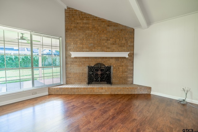 902 Joel Dr, Tyler, TX 75703 - unfurnished living room with a brick fireplace, wood finished floors, and baseboards