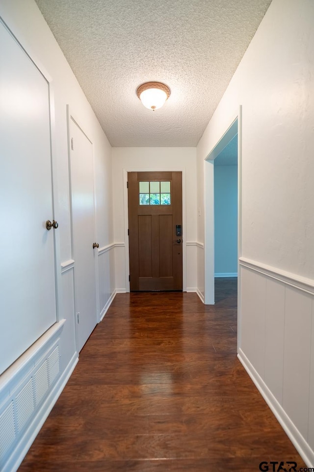 902 Joel Dr, Tyler, TX 75703 - foyer entrance featuring a textured ceiling and wood finished floors