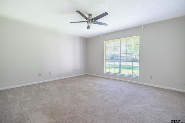902 Joel Dr, Tyler, TX 75703 - spare room featuring a ceiling fan, light colored carpet, a textured ceiling, and baseboards