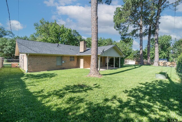 902 Joel Dr, Tyler, TX 75703 - rear view of house with a chimney, a patio area, brick siding, and roof with shingles