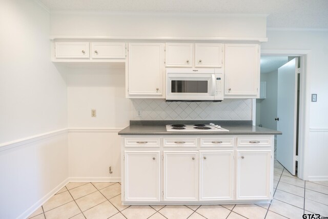 902 Joel Dr, Tyler, TX 75703 - kitchen featuring white appliances, white cabinets, light tile patterned flooring, tasteful backsplash, and ornamental molding
