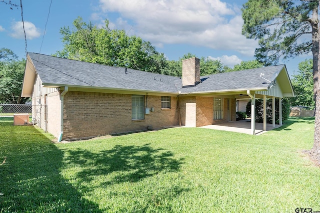 902 Joel Dr, Tyler, TX 75703 - back of house featuring a chimney, a patio area, brick siding, and roof with shingles