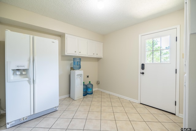 902 Joel Dr, Tyler, TX 75703 - laundry room with cabinet space, hookup for an electric dryer, a textured ceiling, and baseboards