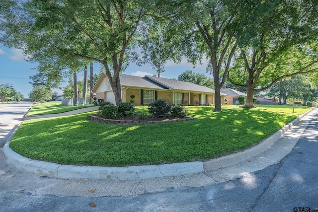 902 Joel Dr, Tyler, TX 75703 - ranch-style home with a front yard, brick siding, and an attached garage