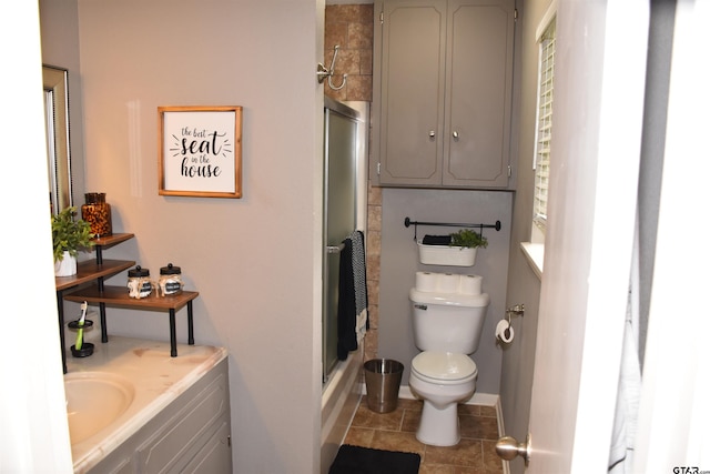 607 Brookhollow Dr, Palestine, TX 75801 - full bath featuring toilet, an enclosed shower, vanity, tile patterned floors, and baseboards