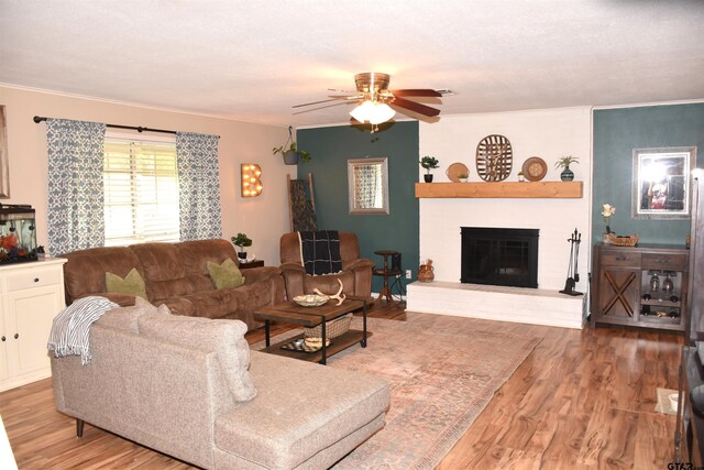 607 Brookhollow Dr, Palestine, TX 75801 - living area featuring a ceiling fan, wood finished floors, a brick fireplace, and ornamental molding