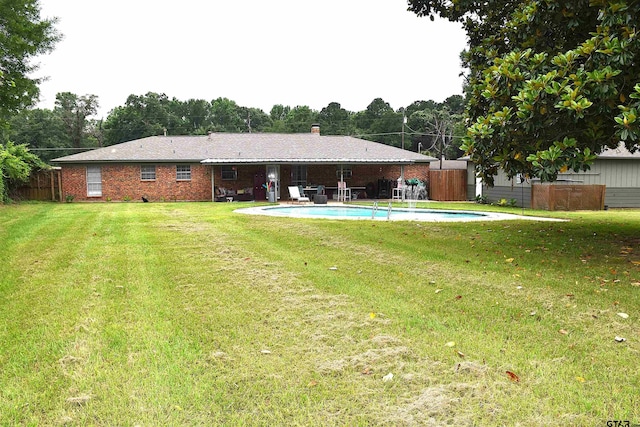 607 Brookhollow Dr, Palestine, TX 75801 - rear view of property featuring a patio area, a chimney, and brick siding