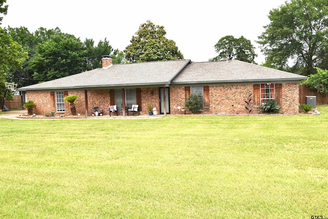607 Brookhollow Dr, Palestine, TX 75801 - ranch-style home featuring a front lawn, a chimney, brick siding, central AC, and a shingled roof