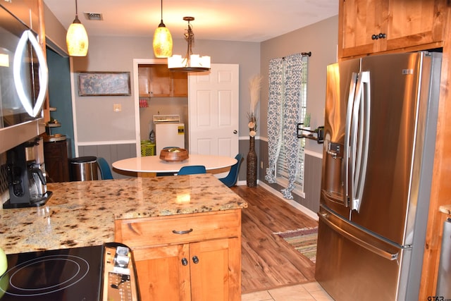 607 Brookhollow Dr, Palestine, TX 75801 - kitchen featuring stainless steel refrigerator with ice dispenser, washer / clothes dryer, a peninsula, decorative light fixtures, and light tile patterned floors