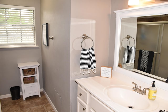 607 Brookhollow Dr, Palestine, TX 75801 - bathroom featuring vanity, a shower with door, and baseboards