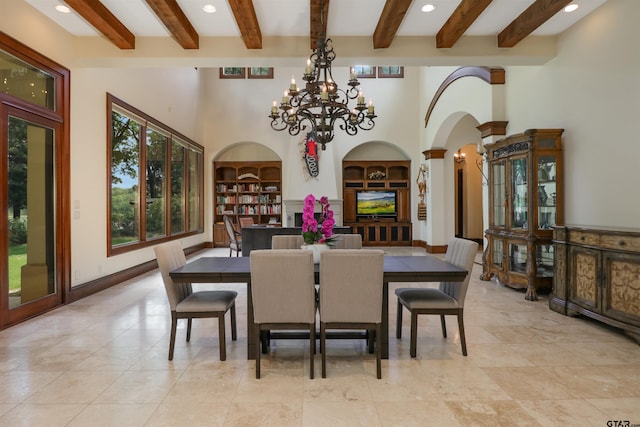 dining area with built in shelves, a notable chandelier, and beam ceiling