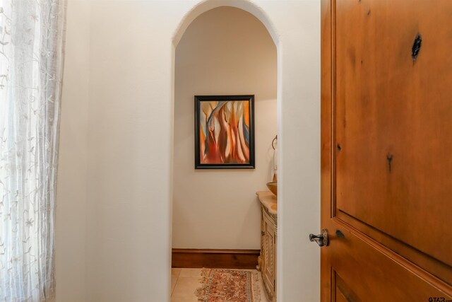 hall with light tile patterned floors