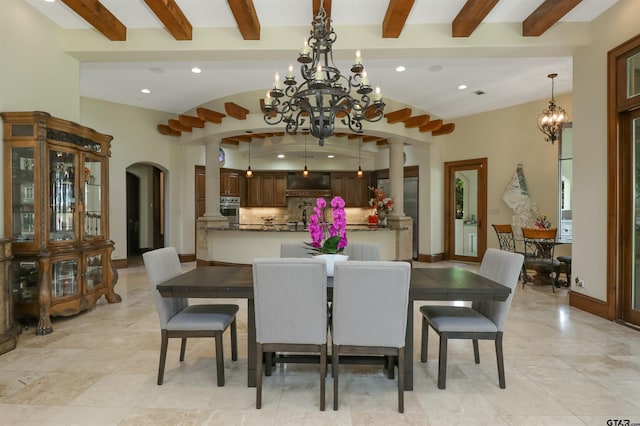 dining space featuring lofted ceiling with beams, a chandelier, and light tile patterned floors