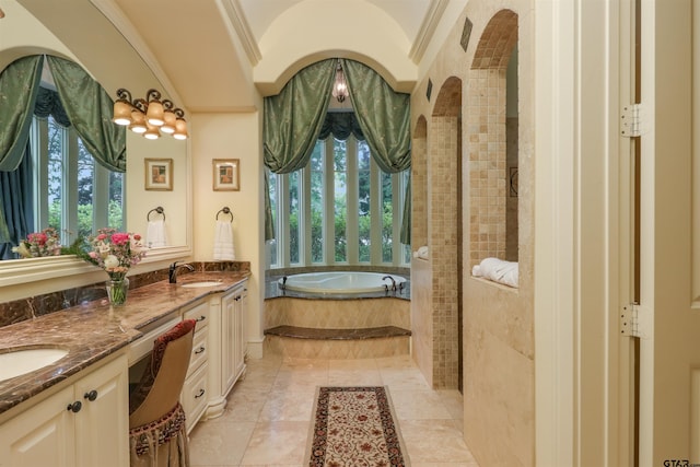 bathroom with vanity, tile patterned floors, crown molding, and tiled tub