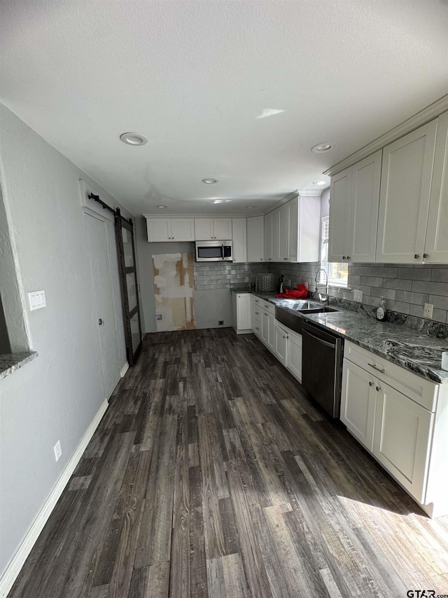 10816 Mountain View Pl, Whitehouse, TX 75791 - kitchen featuring stainless steel appliances, a barn door, dark wood-style flooring, backsplash, and recessed lighting