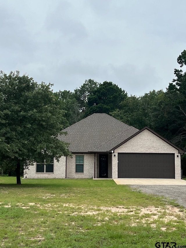 view of front of house with a front lawn and a garage