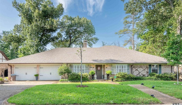 single story home featuring a garage and a front lawn