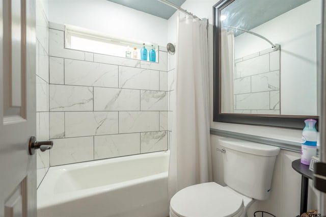 bathroom featuring shower / bath combo and toilet