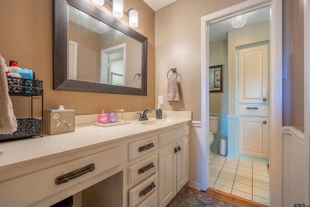 bathroom featuring vanity, toilet, and tile patterned floors