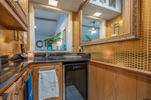 interior space featuring beverage cooler, tile patterned floors, vanity, wood walls, and ceiling fan