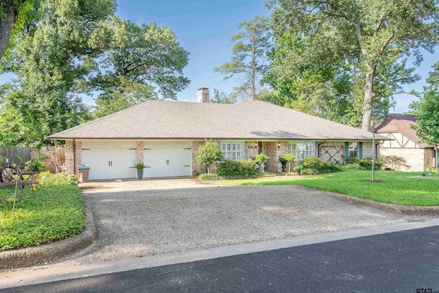 ranch-style house featuring a front yard and a garage