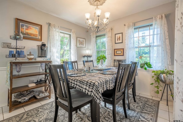 dining room featuring a notable chandelier, a healthy amount of sunlight, and light tile patterned flooring