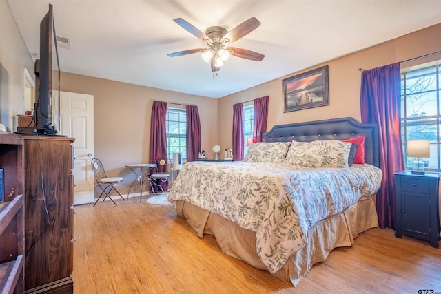 bedroom with ceiling fan and light hardwood / wood-style floors