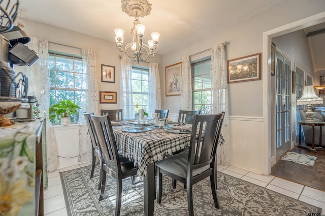 tiled dining space with an inviting chandelier