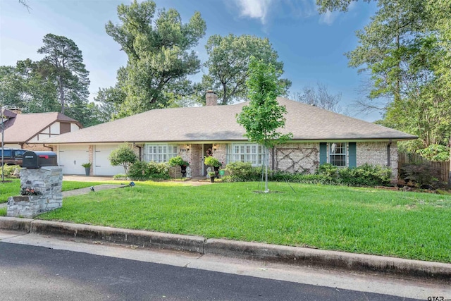 view of front of home with a garage and a front lawn