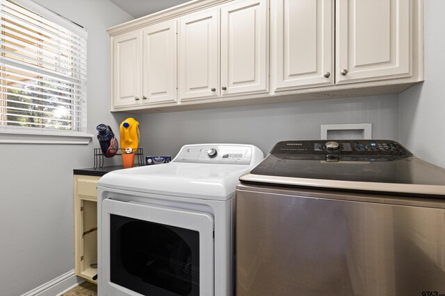 5201 Whitaker Cir, Longview, TX 75605 - washroom with washing machine and dryer and cabinet space