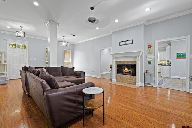 5201 Whitaker Cir, Longview, TX 75605 - living area featuring light wood finished floors, recessed lighting, a ceiling fan, a fireplace, and crown molding