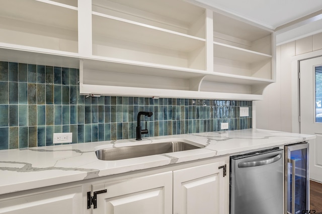 kitchen featuring tasteful backsplash, open shelves, wine cooler, stainless steel dishwasher, and a sink