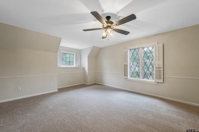 interior space featuring vaulted ceiling, baseboards, and ceiling fan