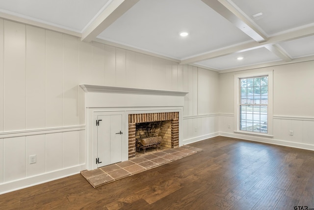 unfurnished living room featuring a fireplace with raised hearth, wood-type flooring, crown molding, beamed ceiling, and a decorative wall