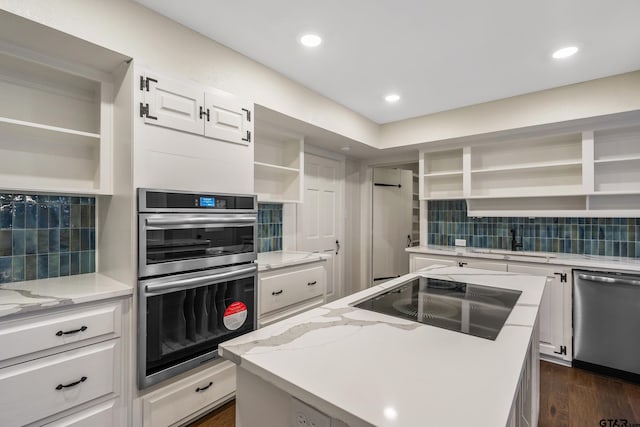 kitchen with decorative backsplash, open shelves, appliances with stainless steel finishes, and a sink