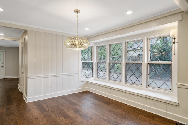 unfurnished dining area with dark wood-type flooring, recessed lighting, baseboards, and ornamental molding