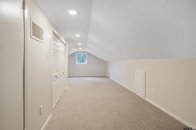 bonus room featuring visible vents, baseboards, light colored carpet, vaulted ceiling, and recessed lighting