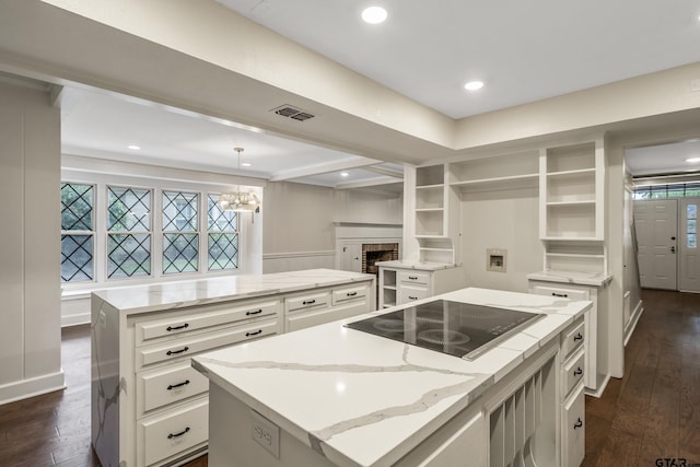 kitchen featuring dark wood-style floors, a center island, black electric stovetop, and open shelves