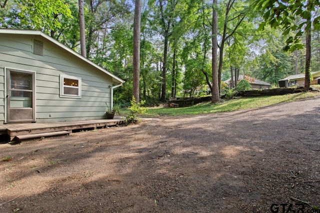 view of property exterior featuring a wooden deck