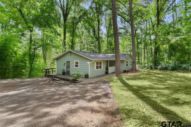 1435 W Hideaway Ln, Hideaway, TX 75771 - view of front of property with a front yard, a wooden deck, and roof with shingles