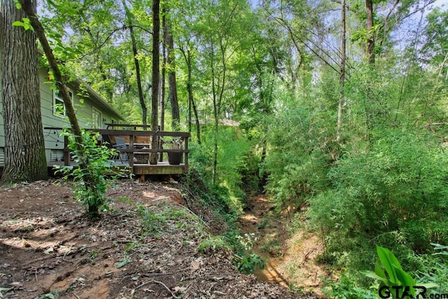 1435 W Hideaway Ln, Hideaway, TX 75771 - view of yard with a wooden deck and a forest view