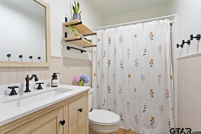 bathroom featuring vanity, toilet, and crown molding