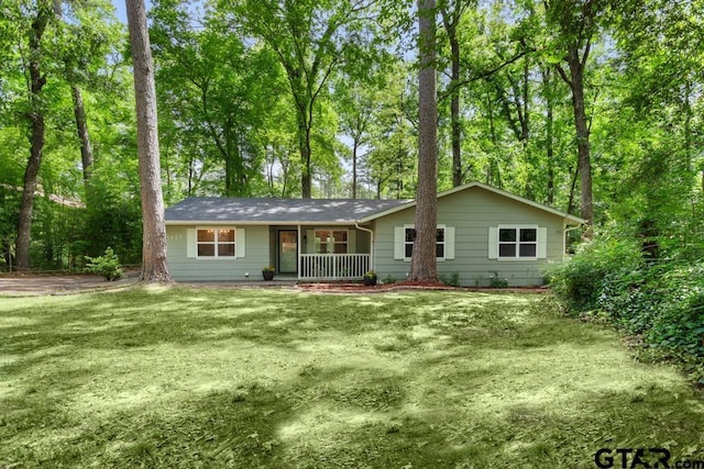 1435 W Hideaway Ln, Hideaway, TX 75771 - ranch-style house featuring a porch and a front lawn
