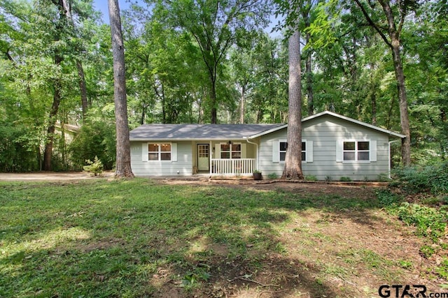 single story home with a front lawn and covered porch