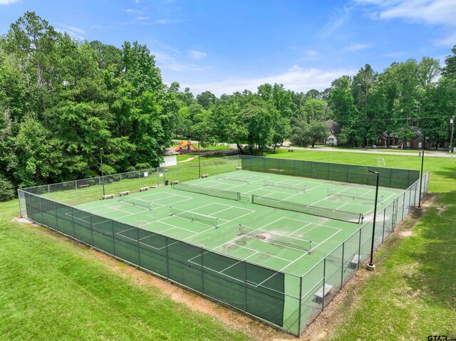 view of sport court featuring a yard