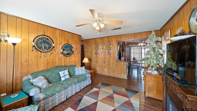 living room with dark hardwood / wood-style floors and ceiling fan