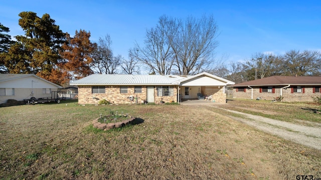 single story home featuring a carport and a front yard