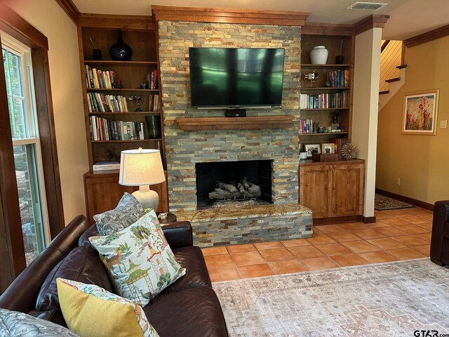 17889 County Road 134, Flint, TX 75762 - tiled living area with built in shelves, ornamental molding, baseboards, and a stone fireplace