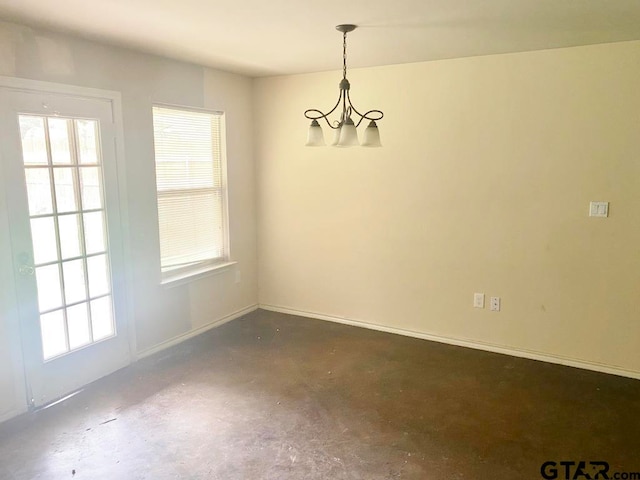 unfurnished dining area featuring a notable chandelier